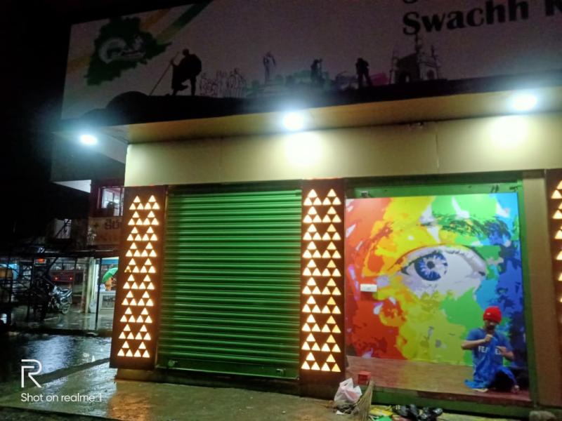 LooCafe facility with Swachh branding and colorful mural at night