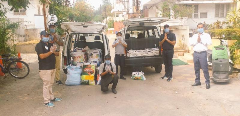 COVID relief donation drive with team members distributing essential supplies